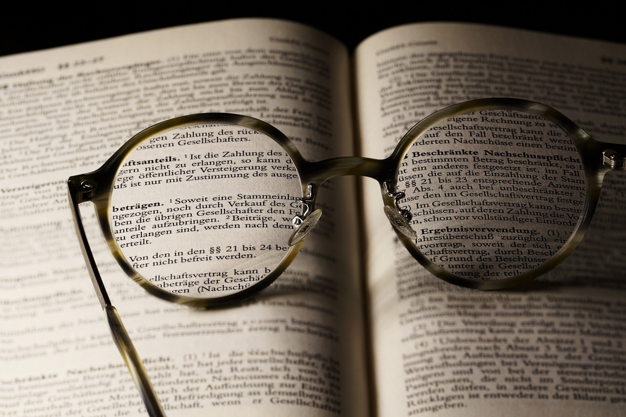 Terms and Conditions image - glasses on open book